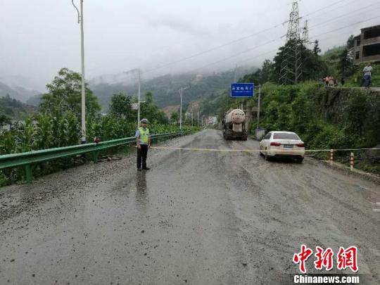 图为山体滑坡后公安人员拉起警戒线 钟欣 摄